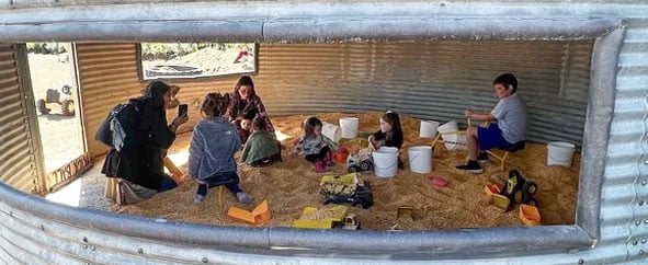 Kids playing in in the cornbin